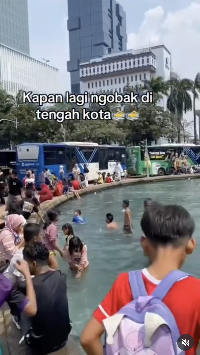 Orang mandi di air mancur Thamrin